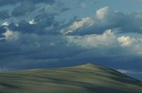 Dunes and dramatic clouds at sunset