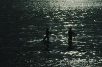 Silhouettes of boys on pier