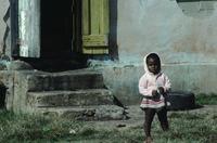 Small child and house with yellow shutter