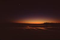 Sunset on beach, with moon