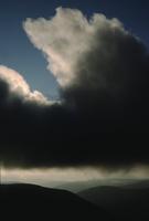 Repeating horizontals: Dark clouds over hills