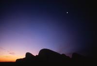 Silhouette of central cairn and predawn sky
