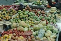Closeups of corn and fruit in a market