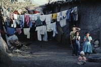 Children in front of home; multiple clotheslines