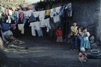 Children in front of home; multiple clotheslines