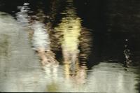 Two people reflected in rippling water