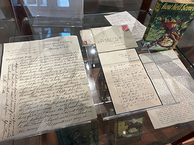 Glass case with handwritten letters.