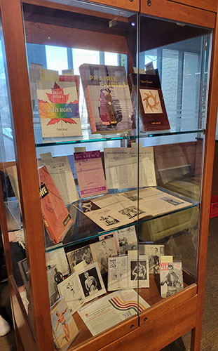 Display case with queer archival materials.