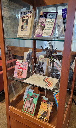 Display case of queer archival material.