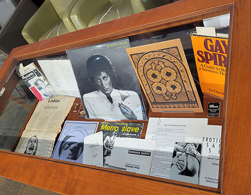 Display case with queer archival materials.